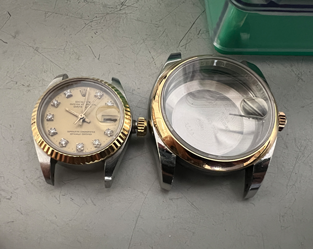Geöffnetes Rolex Uhrengehäuse neben dem Zifferblatt mit Uhrwerk – Detailaufnahme vor der Reinigung