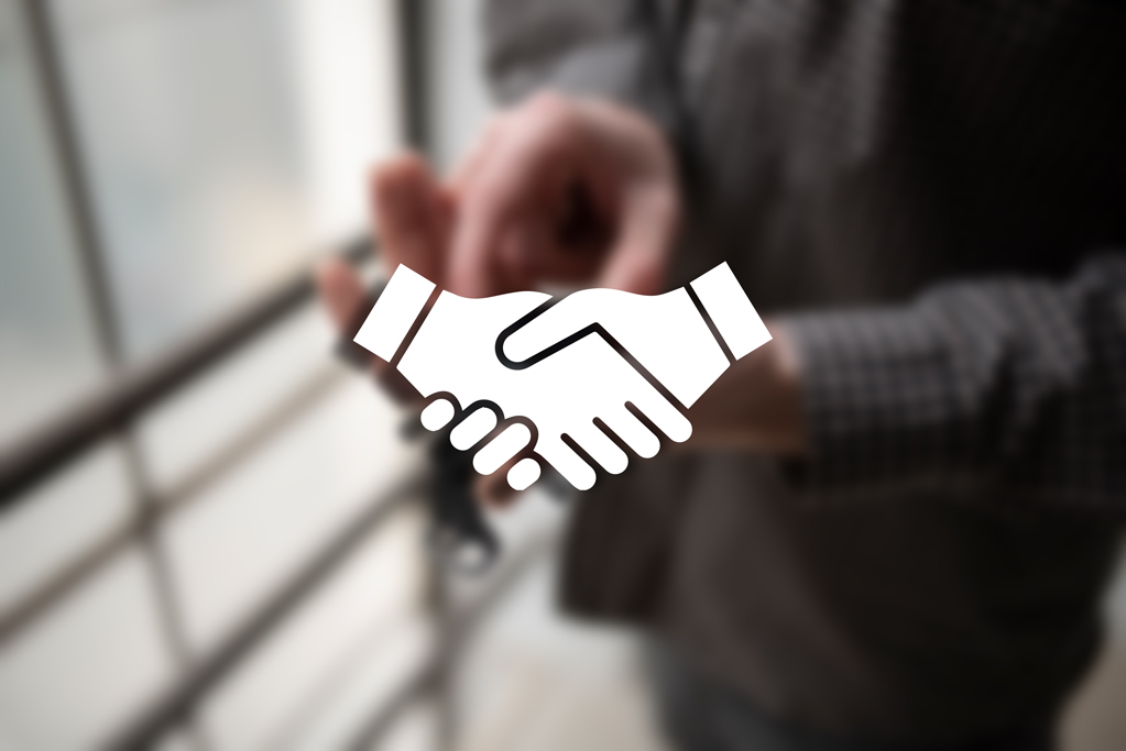 Symbolischer Händedruck als Darstellung des Verkaufsprozesses von Uhren-Konvoluten.